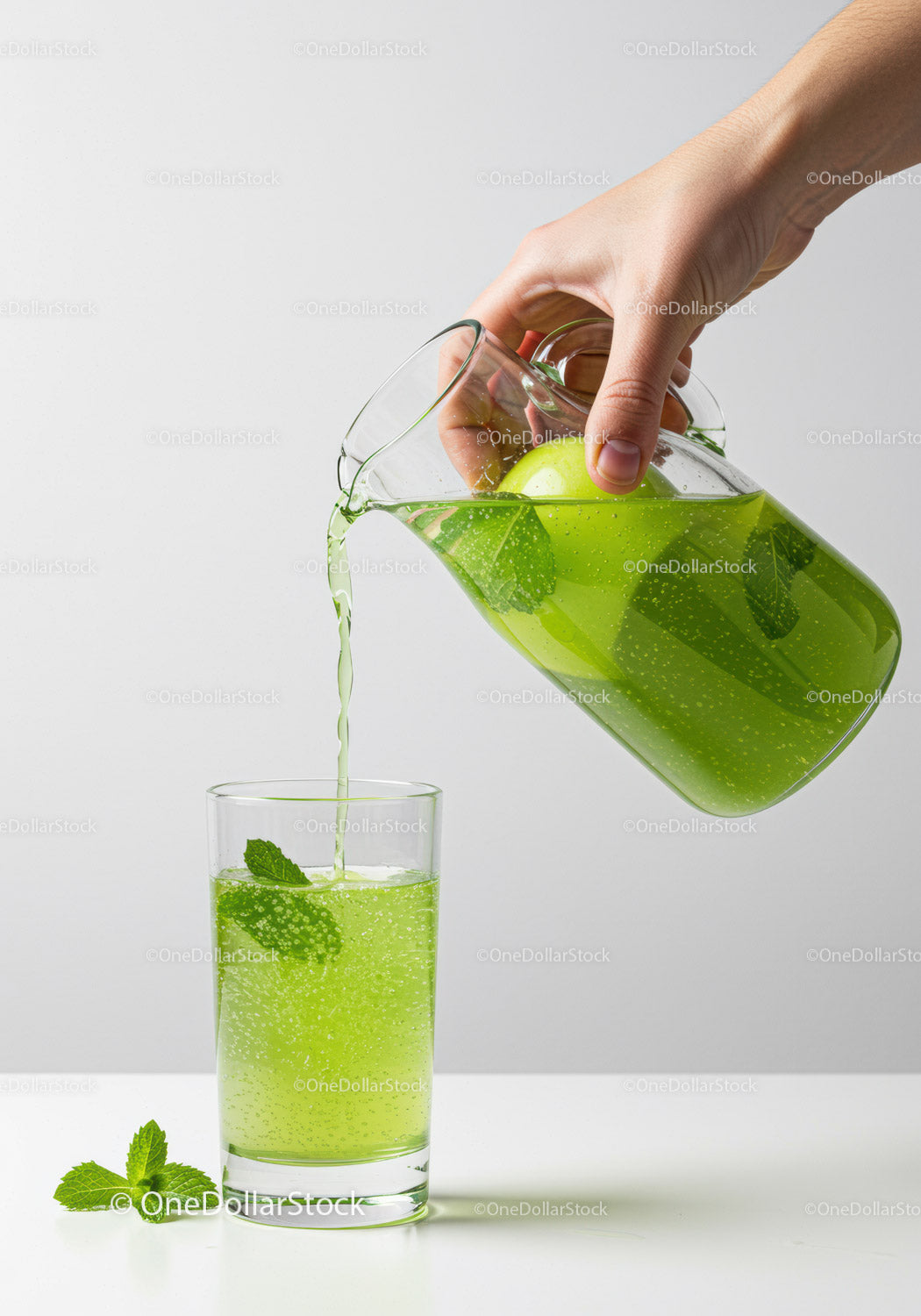 Refreshing green apple mint drink poured into glass