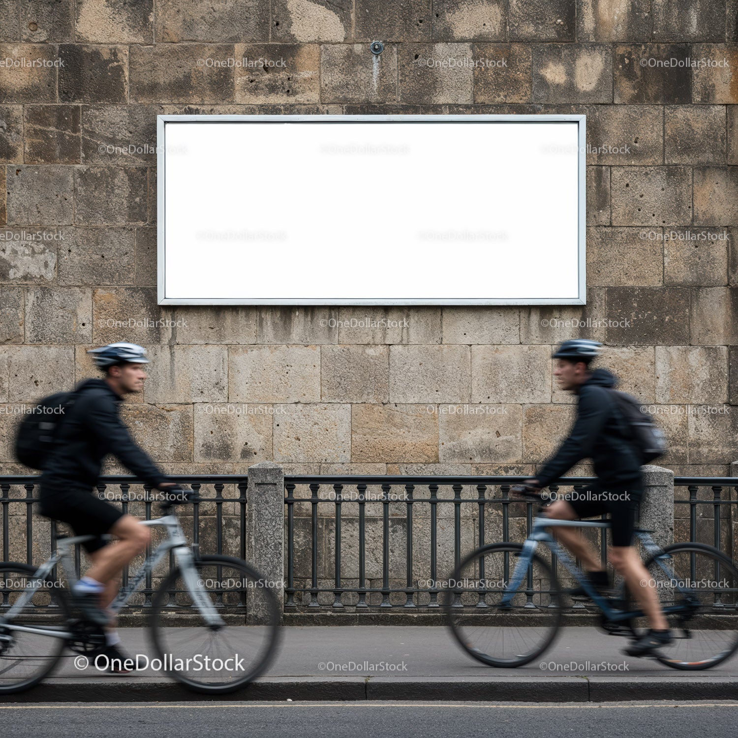 Two Cyclists Passing by Blank Urban Billboard on Stone Wall