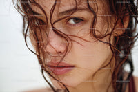 Close-up of Young Woman with Wet Hair and Water Droplets