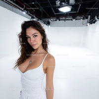 Portrait of a Young Woman in a White Dress in a Studio Setting