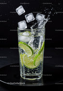 Refreshing lime slices splash in sparkling water glass