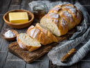 Rustic Artisan Bread on Wooden Table with Kitchen Background