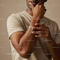Close-Up of Man Applying Lotion to Arm for Skin Hydration