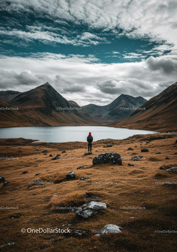 Scenic Mountain Landscape with Lake and Hiker in Wilderness