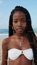 Stylish Young Woman with Braided Hair Posing at the Beach