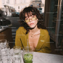 Stylish Young Woman Wearing Yellow Blazer with Sunglasses in Urban Setting