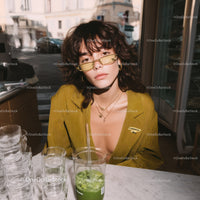 Stylish Young Woman Wearing Yellow Blazer with Sunglasses in Urban Setting