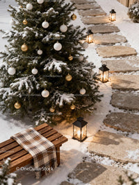 Snowy Christmas Tree with Lit Lanterns and Cozy Bench