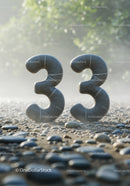 Number Thirty Three Made of Smooth Stone on Pebble Ground