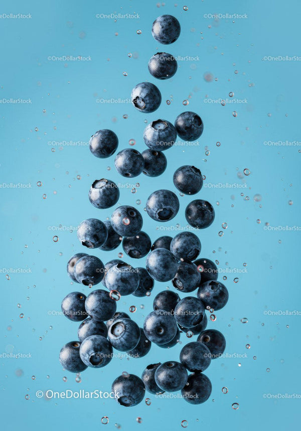 Fresh blueberries suspended in clear water with bubbles