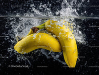 Vibrant Yellow Bananas Splashing into Water in Dynamic Scene