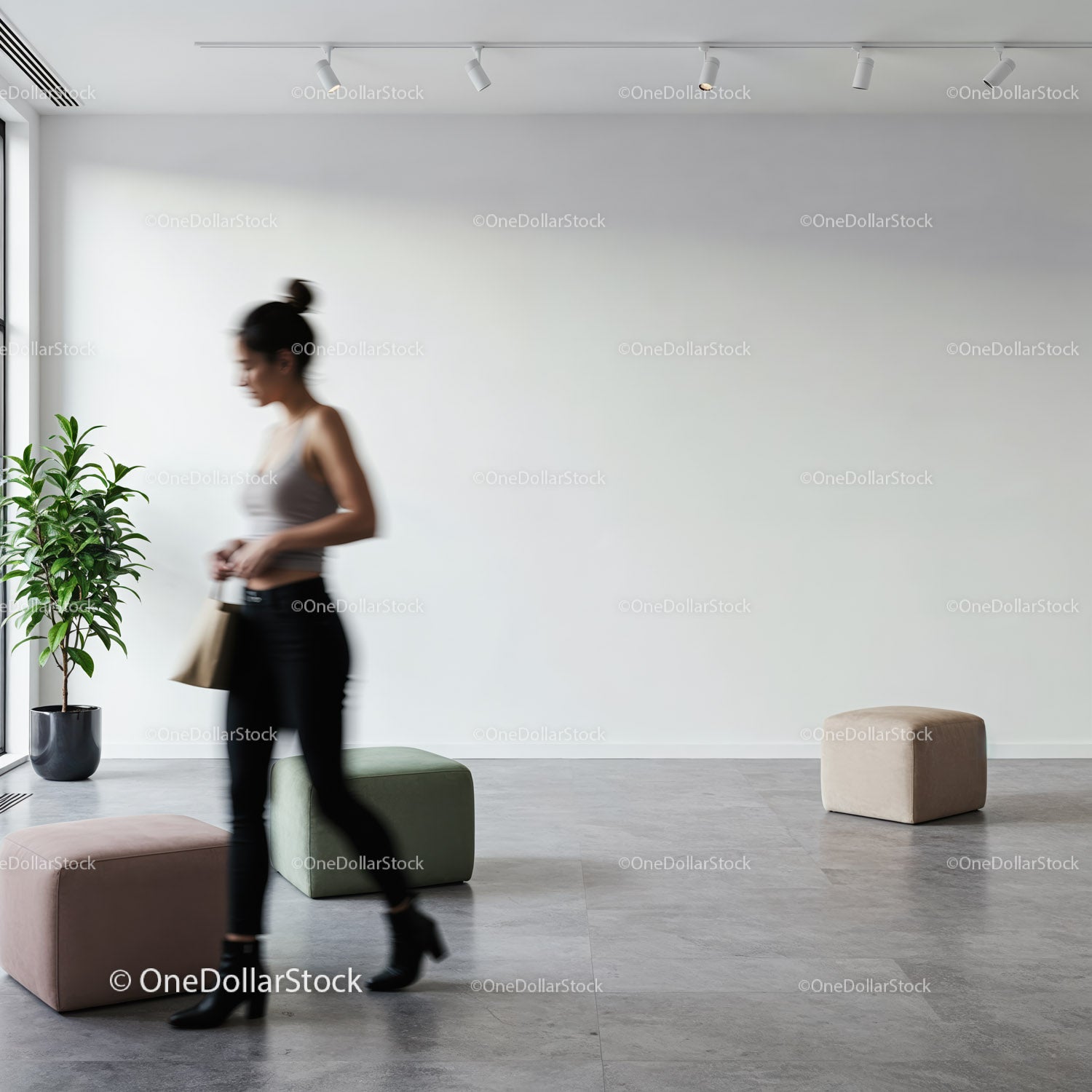 Woman walking past modern pouf seats in minimal interior