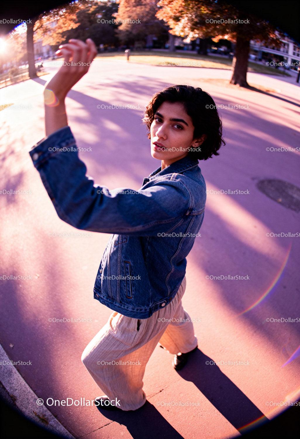 Young woman posing dynamically outdoors in sunset light