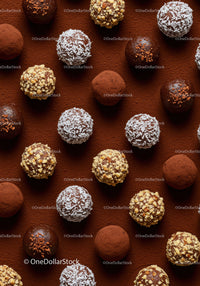 Assorted gourmet chocolate truffles on cocoa powder