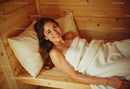 Young Woman Relaxing in Cozy Wooden Bedroom with Warm Atmosphere