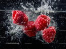 Fresh Raspberries Splashing in Water with Vibrant Red Color
