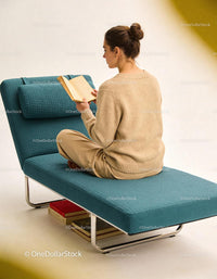 Woman Reading a Book Relaxed on Modern Blue Chaise Lounge