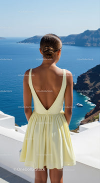 Woman in Yellow Dress Enjoying Scenic Ocean View