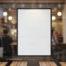 Blank black framed poster hanging indoors in cafe