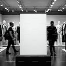Blank display board in modern clothing store interior