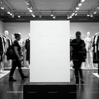 Blank display board in modern clothing store interior