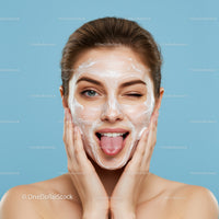 Young Woman Applying Facial Cream with Skincare Mask on Blue Background