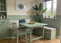 Bright and Airy Kitchen Nook with Green Plants and Cozy Seating