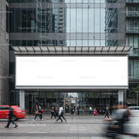 Busy urban street with giant blank billboard on glass building