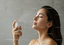 Young Woman Spraying Facial Mist for Hydration and Refreshment