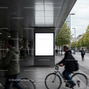 Empty urban billboard with busy pedestrian cyclists