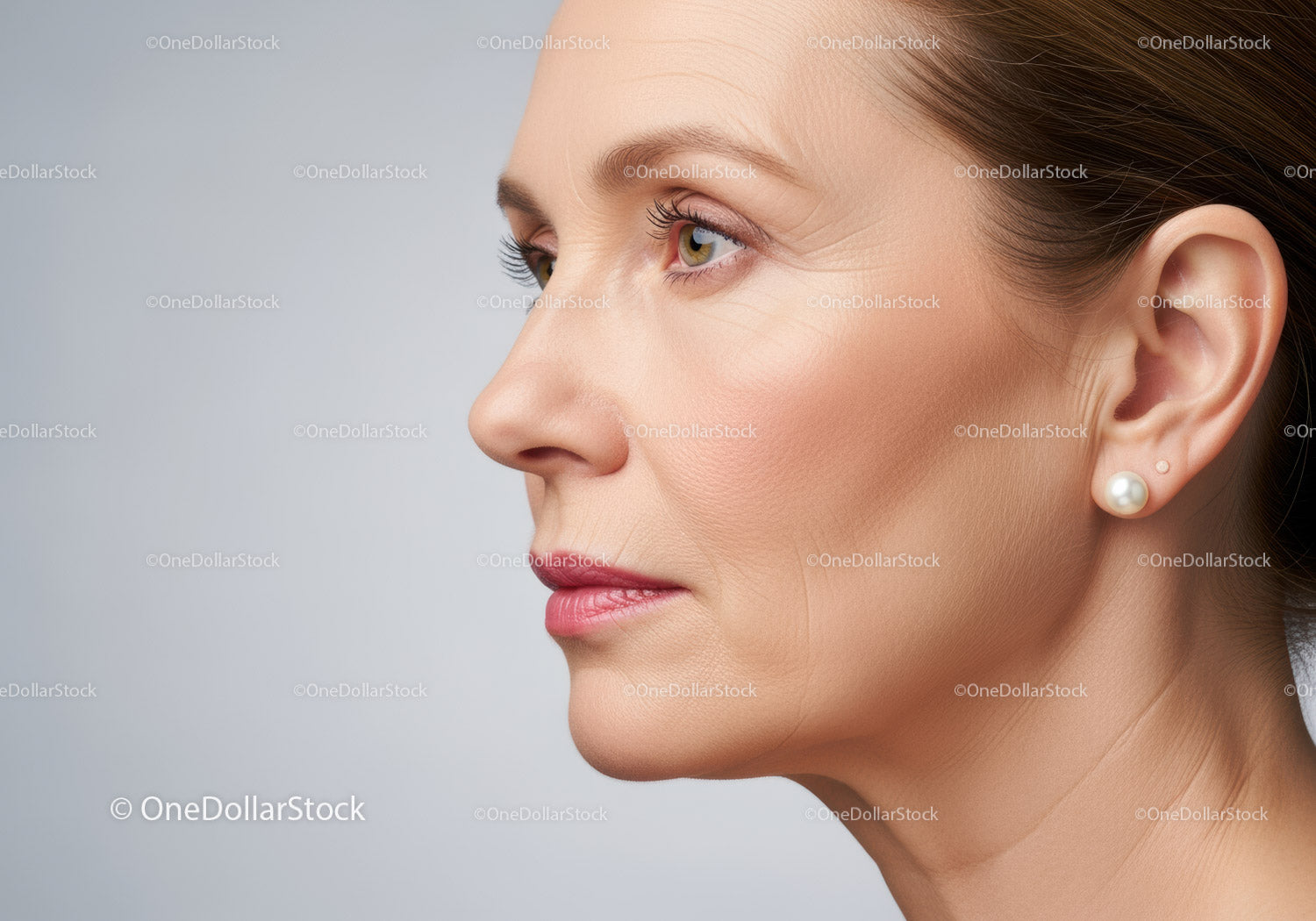 Elegant Mature Woman Portrait with Pearl Earring and Soft Makeup