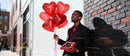 Man Holding Heart Balloons and Chocolate Box Outdoors