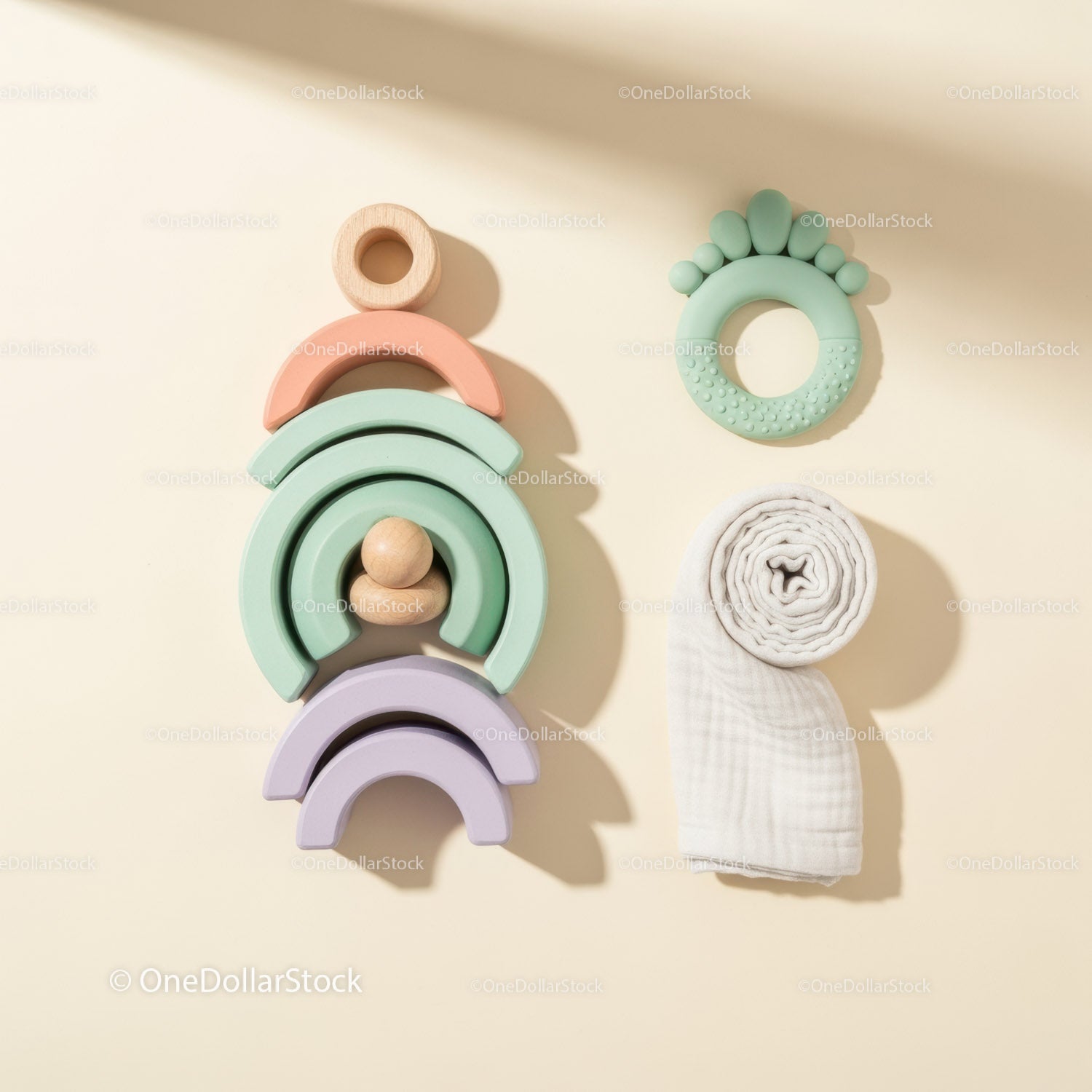 Minimalist pastel baby toys and organic swaddle cloth