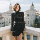 Elegant Woman in Black Lace Dress on City Balcony with Skyline View