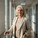 Elegant Senior Woman in Beige Blazer Standing in Modern Indoor Corridor