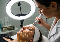 Woman Receiving Facial Skin Care Therapy in Modern Clinic
