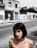 Young woman with short black hair standing on urban street
