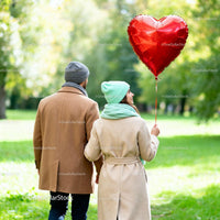 Couple Walking in Park with Heart Shaped Balloon