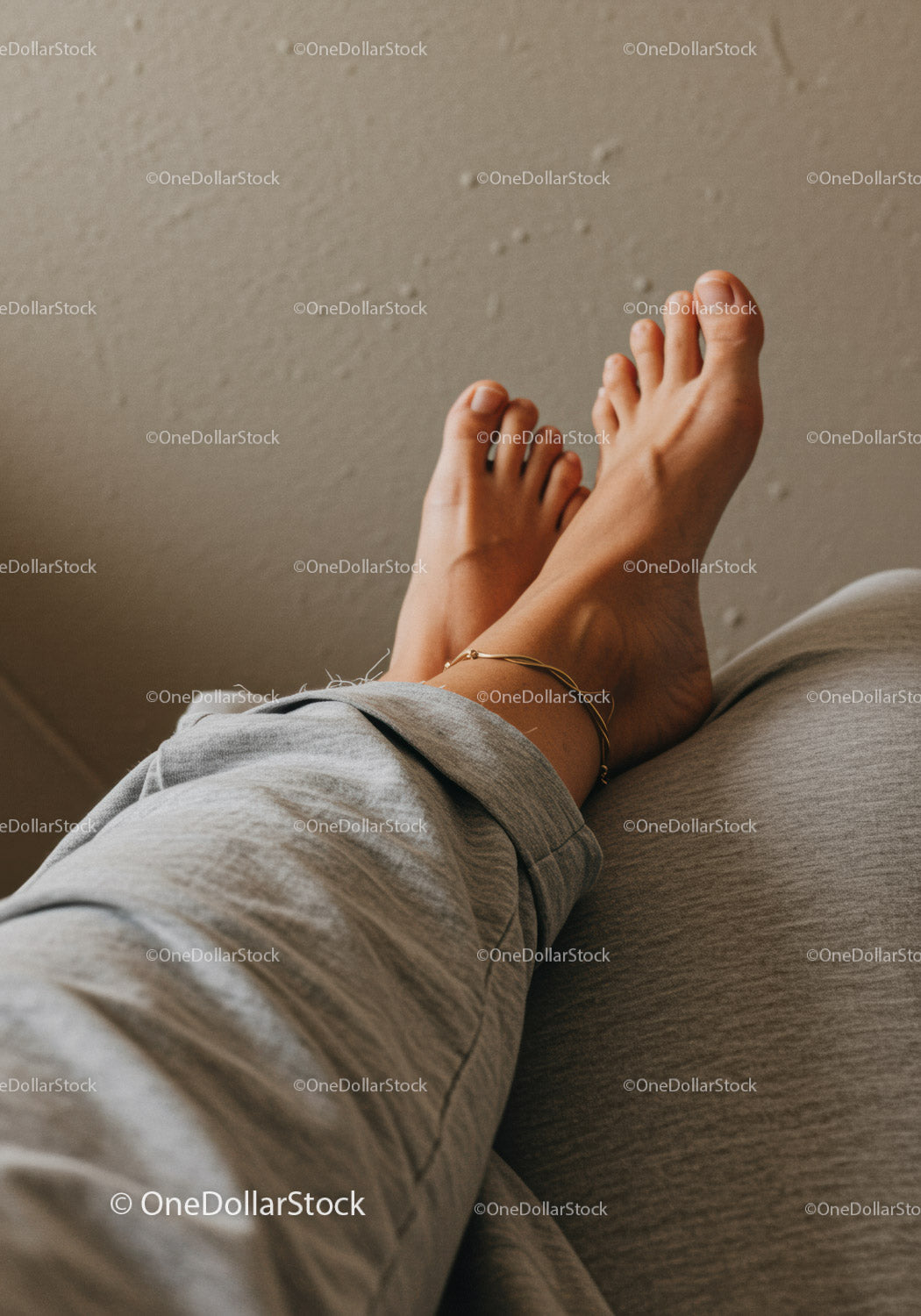 Close-Up of Bare Feet Relaxing on Couch with Casual Attire