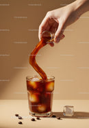 Pouring cold brew coffee over ice cubes in glass