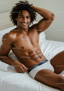 Smiling muscular man relaxing on bed in white underwear