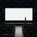 Silhouette of man walking on empty cinema stage