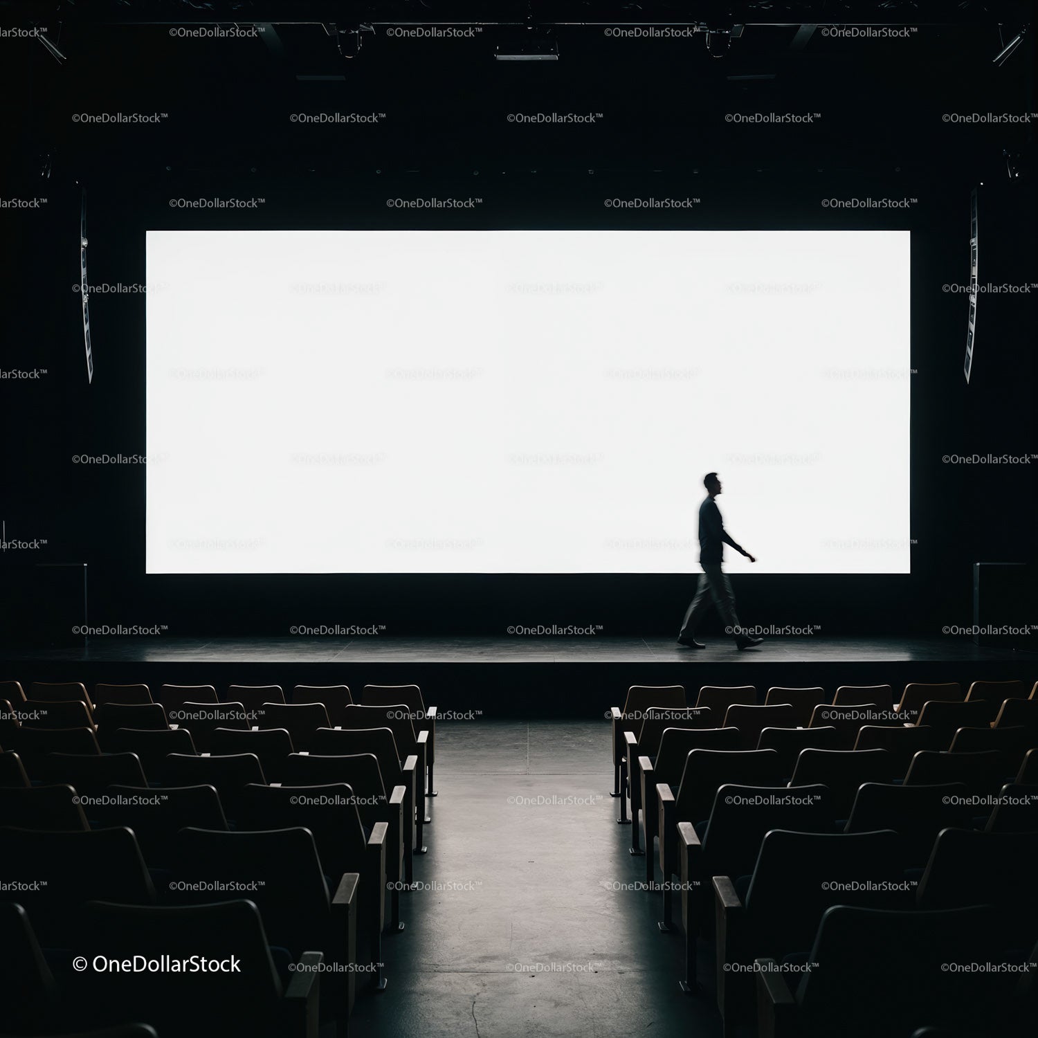 Silhouette of man walking on empty cinema stage