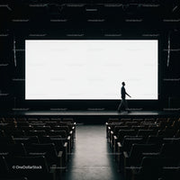 Silhouette of man walking on empty cinema stage