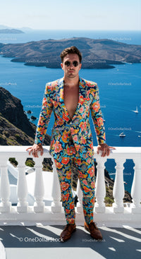 Man in vibrant floral suit overlooking scenic sea view