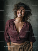 Happy Woman with Curly Hair Wearing Burgundy Blouse and Beige Pants
