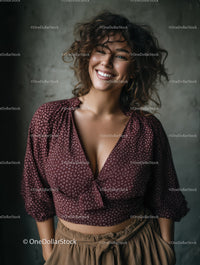 Happy Woman with Curly Hair Wearing Burgundy Blouse and Beige Pants