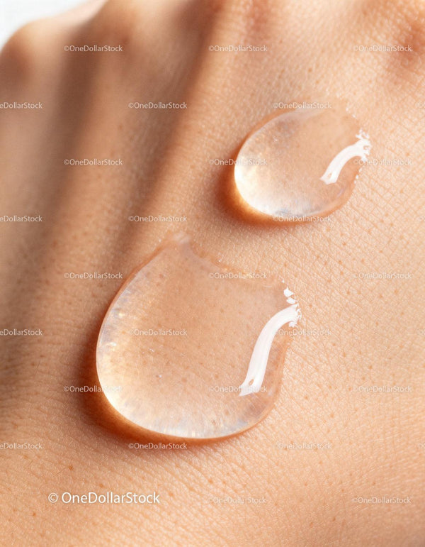 Clear Serum Drops on Smooth Skin Surface