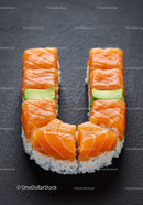Fresh salmon sushi arranged in a U shape with avocado