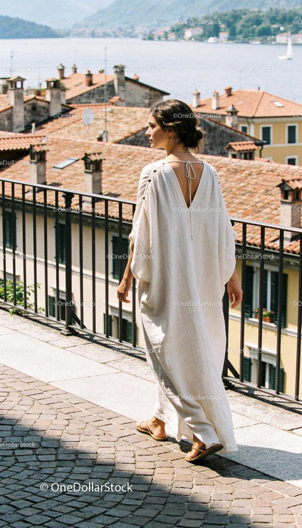 Woman in White Dress Walking Along Scenic Terrace